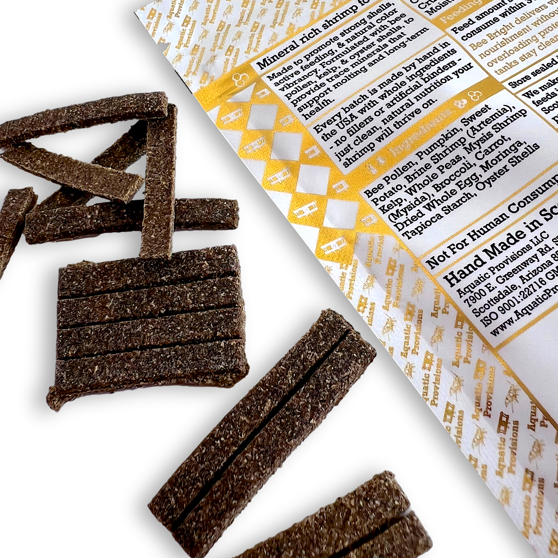 Brown neocaridina shrimp treats with a product label on a white background