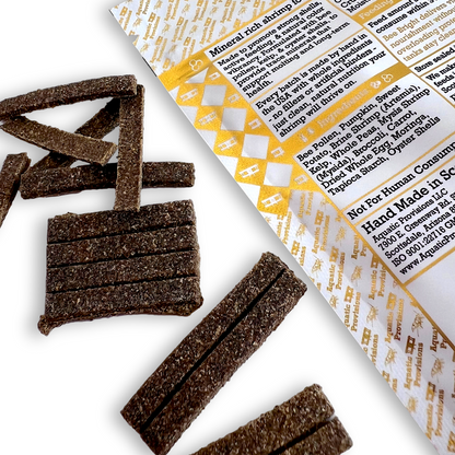 Brown neocaridina shrimp treats with a product label on a white background